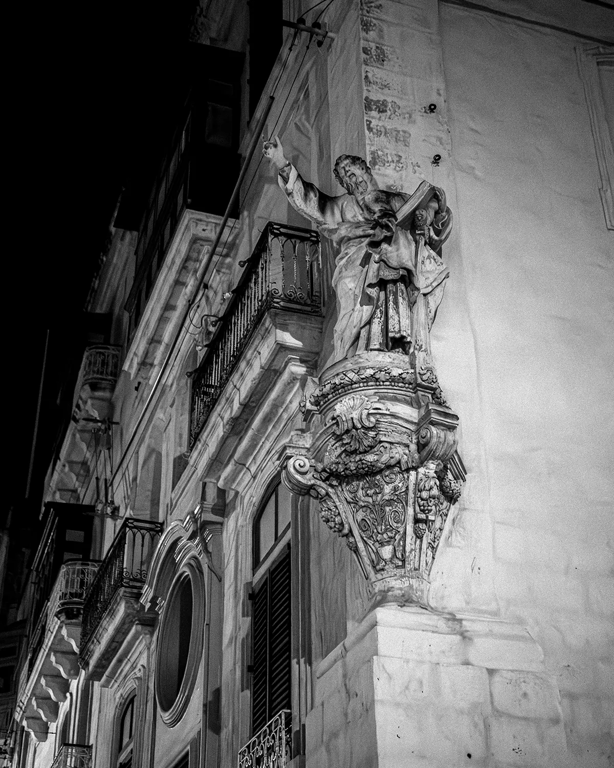 Ivan Grech — promotional portrait beside a doorway, warm tones and grayscale split